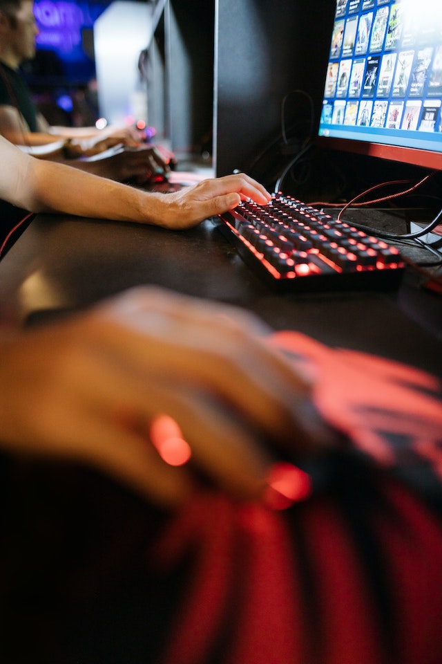 A close up of office workers typing on computer keyboards.